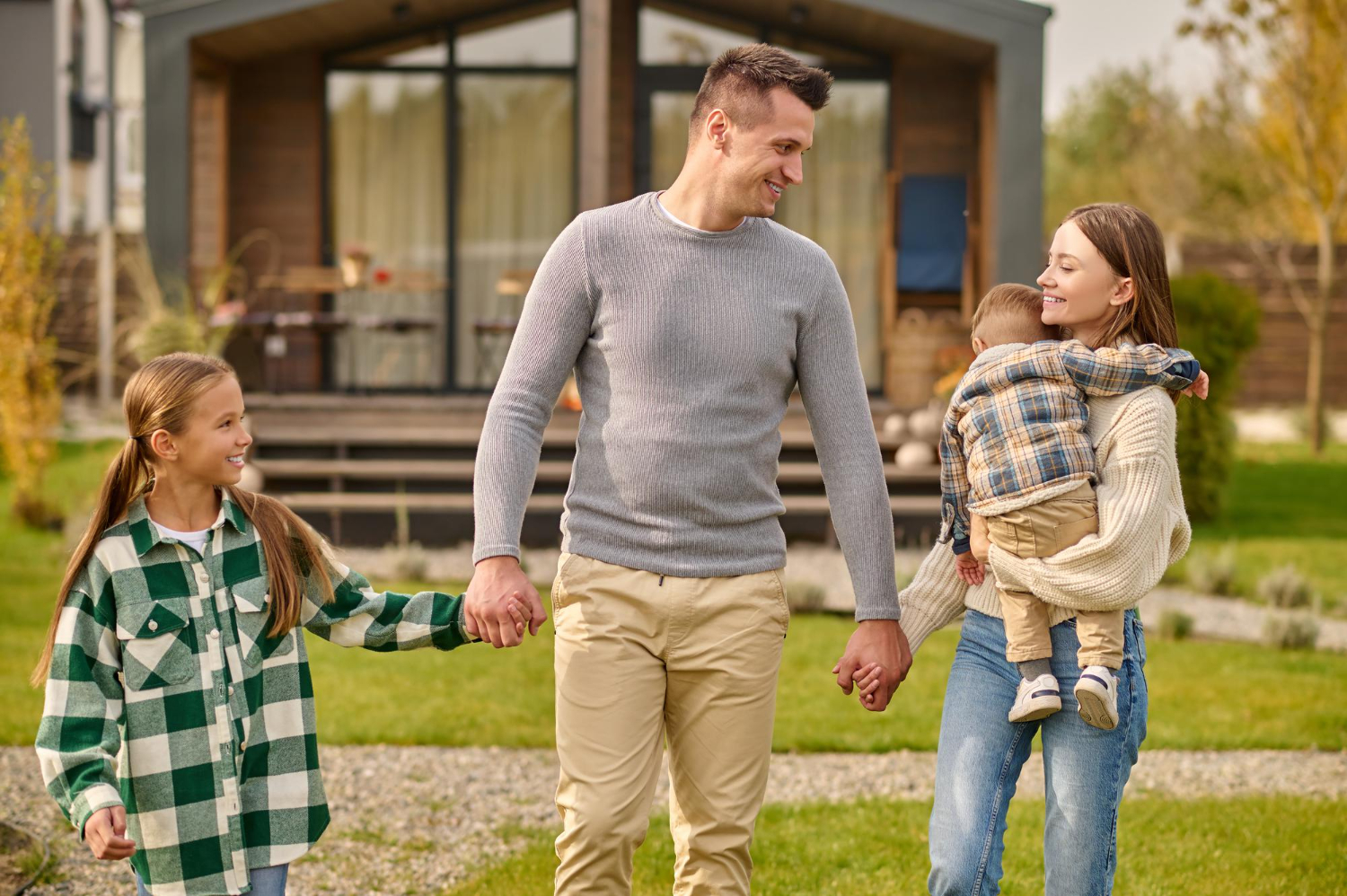 Family standing outside their new home after securing an ITIN loan.