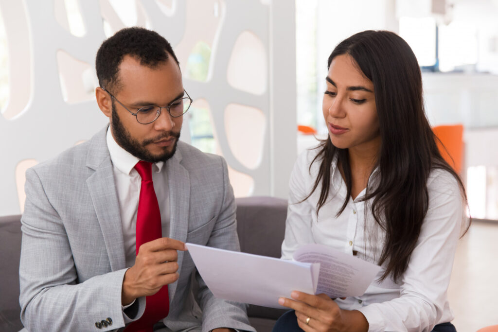 Loan officer explaining ITIN mortgage loan terms to a borrower.