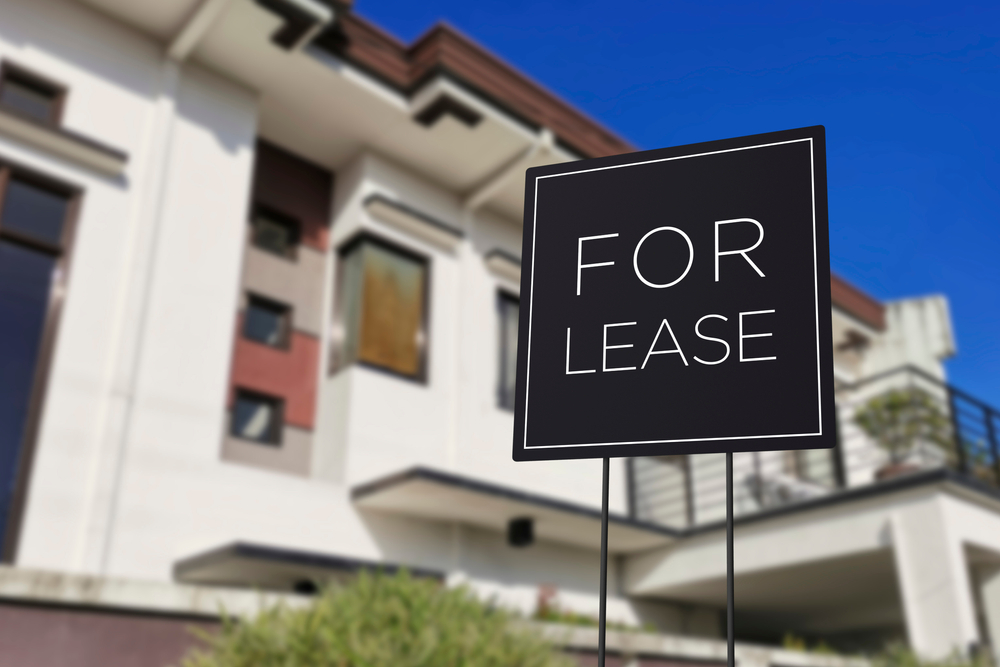 Modern rental property with black For Lease sign in front yard