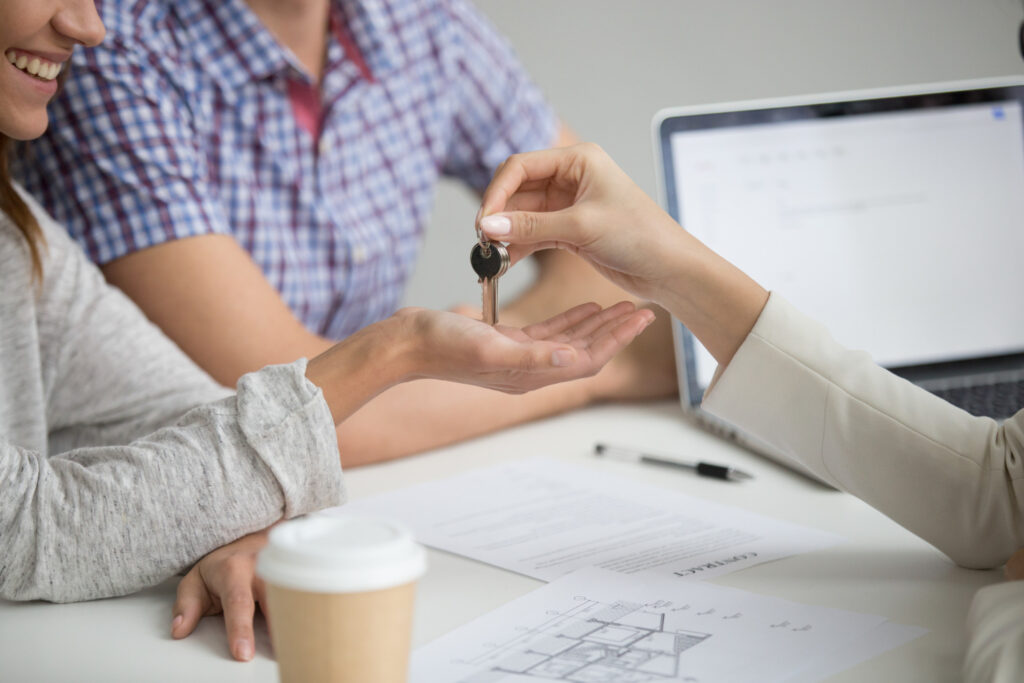 Homebuyers receiving keys after mortgage approval.
