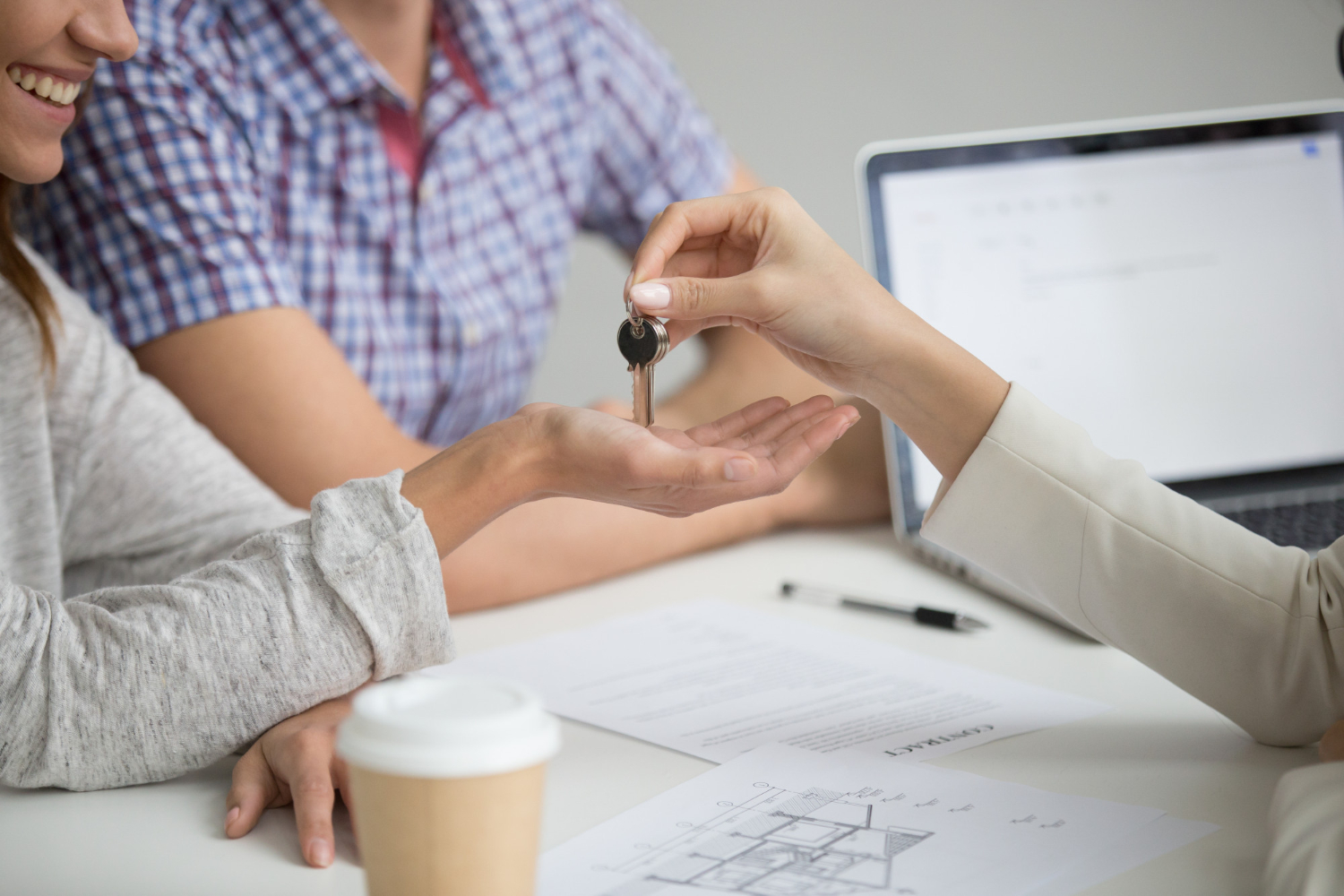 Homebuyers receiving keys after mortgage approval.